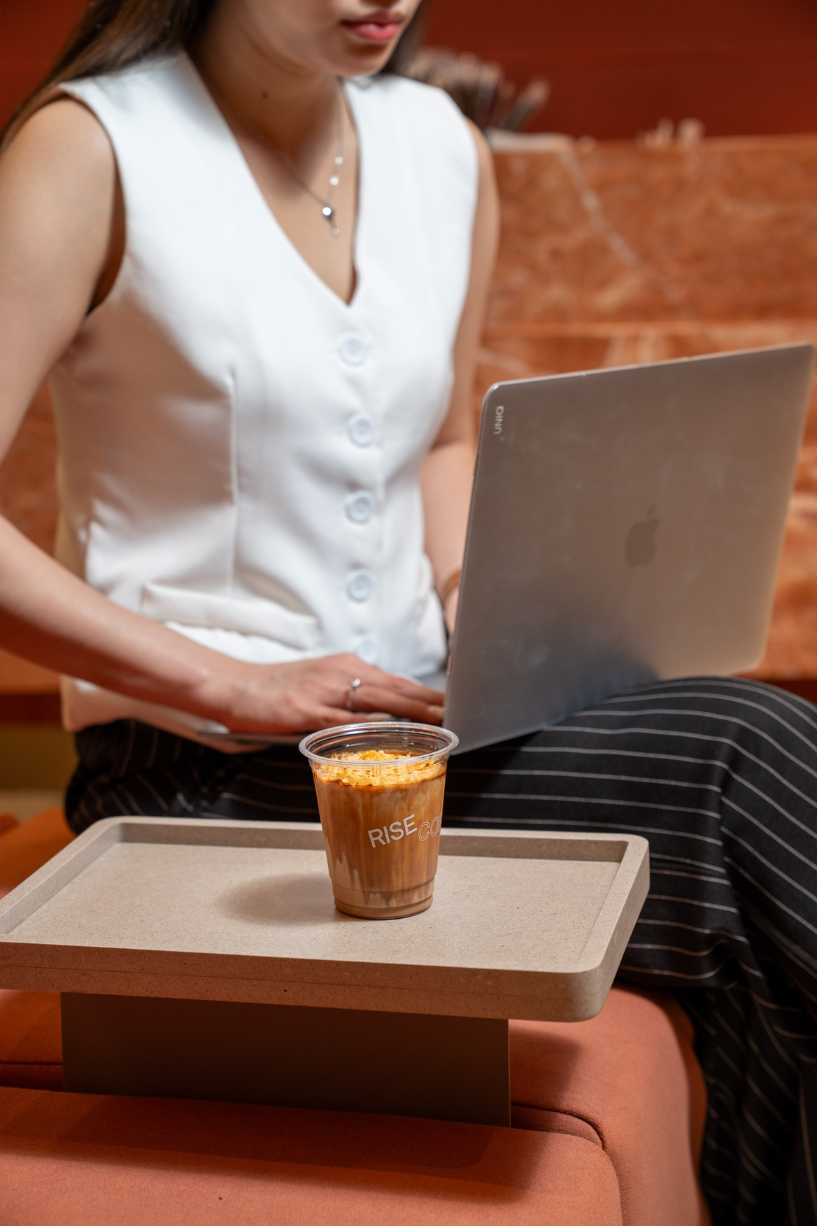 A woman spending time in a café, an ideal part of solo travel in Bangkok